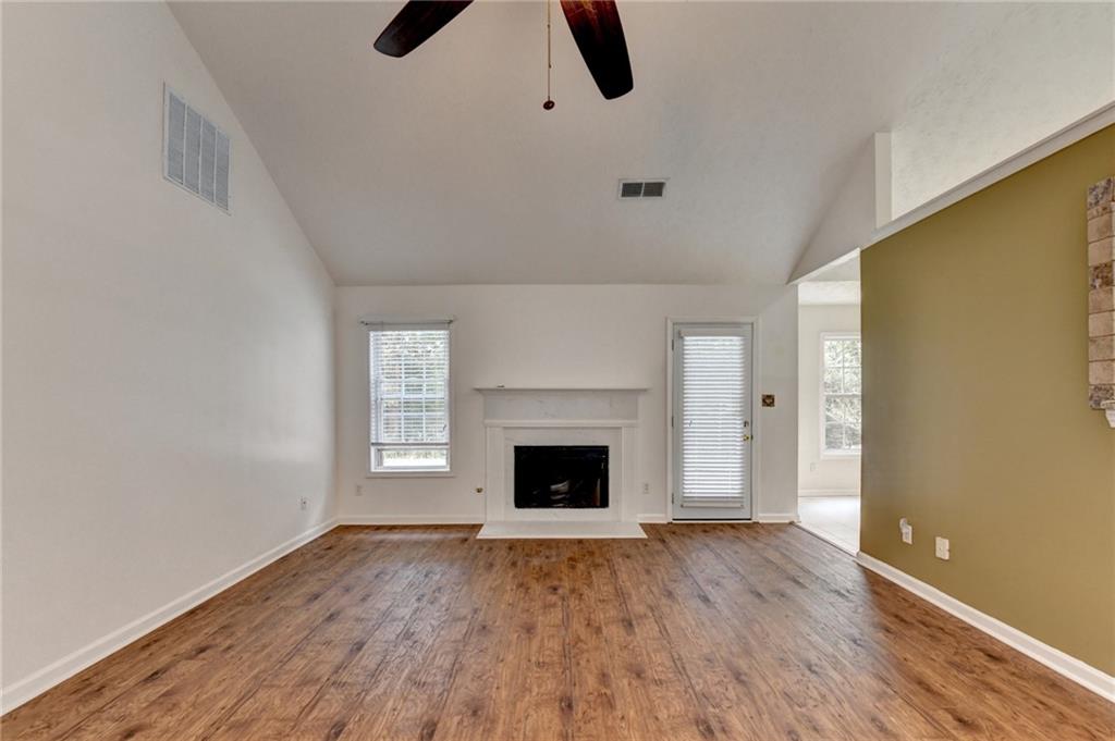 3555 Rivers End Place Buford, GA 30519 - Photo 11 of 49 wooden floor fireplace and natural light in room