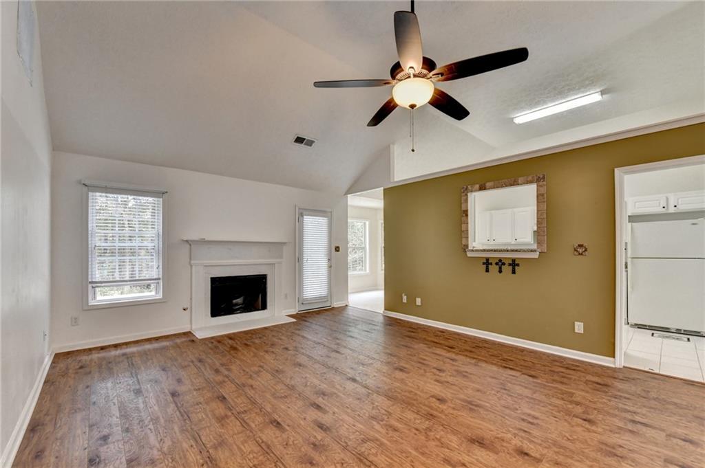 3555 Rivers End Place Buford, GA 30519 - Photo 12 of 49 a view of an empty room with window and wooden floor