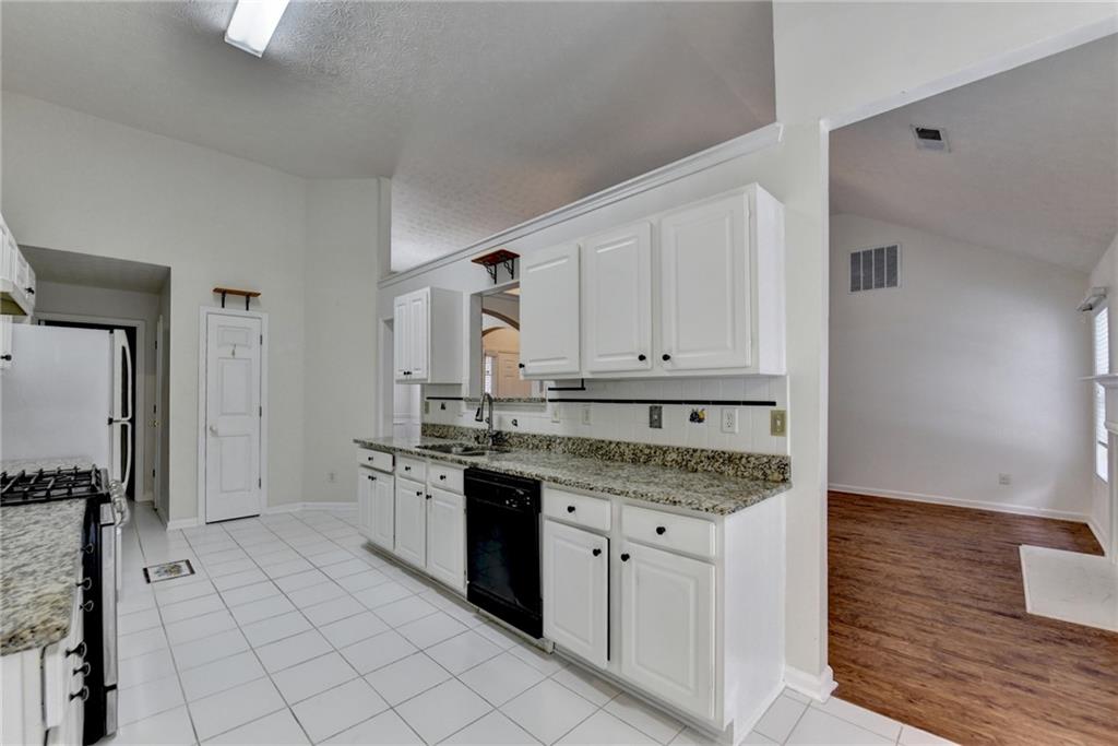 3555 Rivers End Place Buford, GA 30519 - Photo 18 of 49 a kitchen with stainless steel appliances granite countertop a sink and cabinets