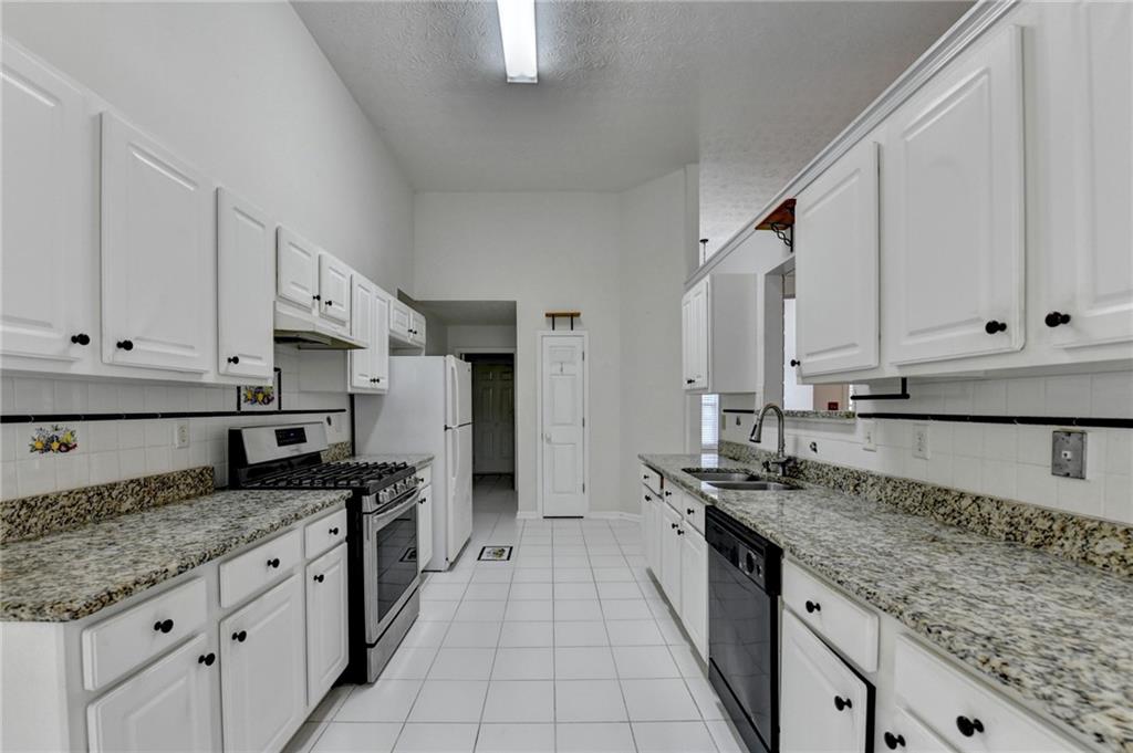 3555 Rivers End Place Buford, GA 30519 - Photo 19 of 49 a kitchen with stainless steel appliances granite countertop a sink stove and cabinets