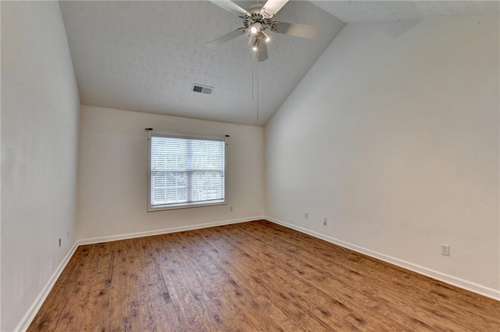 3555 Rivers End Place Buford, GA 30519 - Photo 23 of 49 wooden floor in an empty room with a window