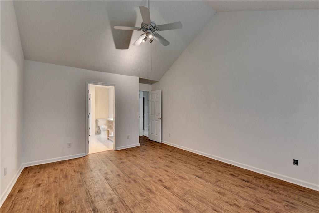 3555 Rivers End Place Buford, GA 30519 - Photo 25 of 49 an empty room with wooden floor ceiling fan and windows