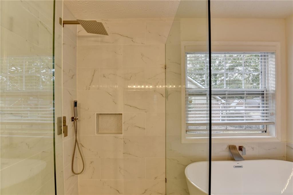 3555 Rivers End Place Buford, GA 30519 - Photo 29 of 49 a bathroom with a bathtub and shower