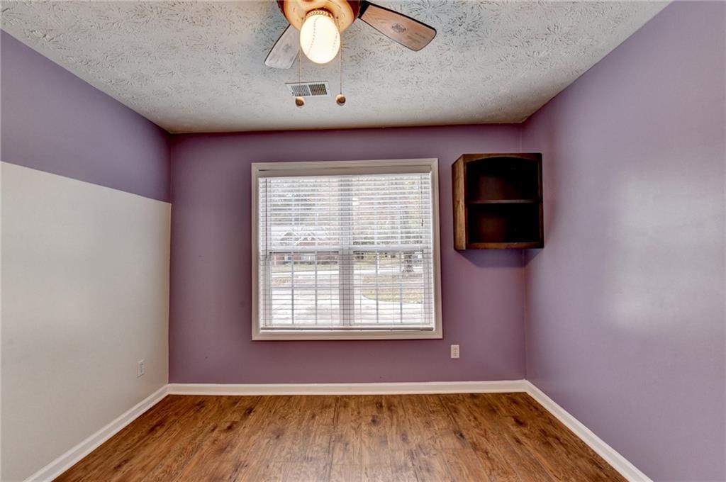 3555 Rivers End Place Buford, GA 30519 - Photo 32 of 49 an empty room with wooden floor and windows