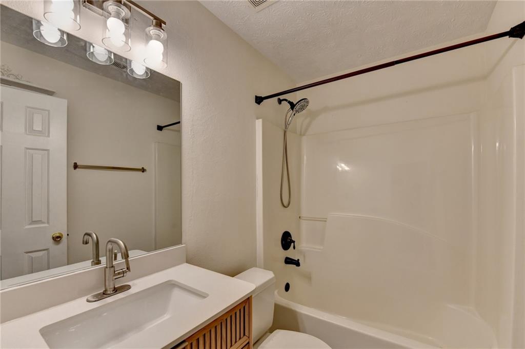 3555 Rivers End Place Buford, GA 30519 - Photo 36 of 49 a bathroom with a sink mirror toilet and bathtub