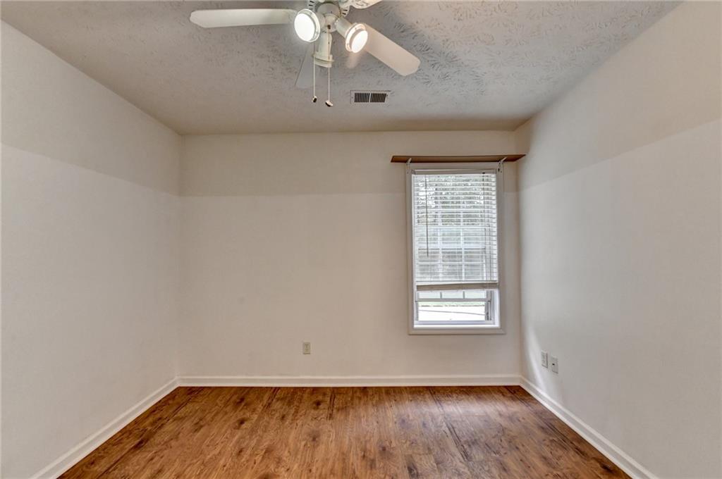 3555 Rivers End Place Buford, GA 30519 - Photo 38 of 49 wooden floor in an empty room with a window
