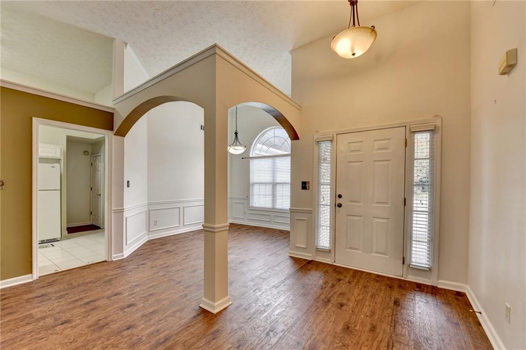 3555 Rivers End Place Buford, GA 30519 - Photo 4 of 49 a view of empty room with wooden floor and fan