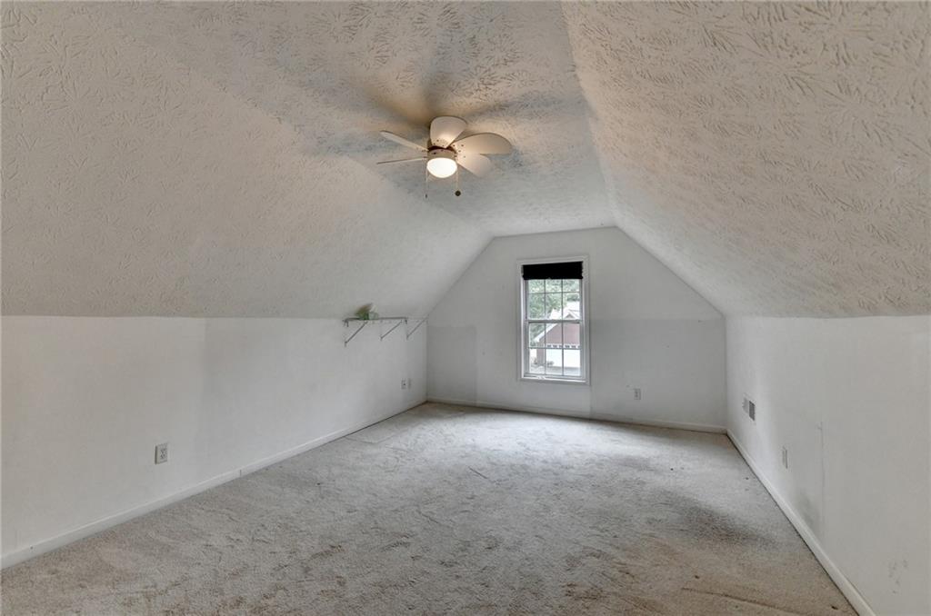 3555 Rivers End Place Buford, GA 30519 - Photo 42 of 49 an empty room with a window and ceiling fan