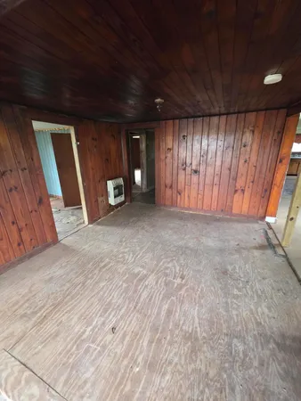 a view of wooden floor and windows in a room