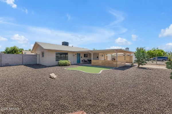 a front view of a house with a yard and a garage