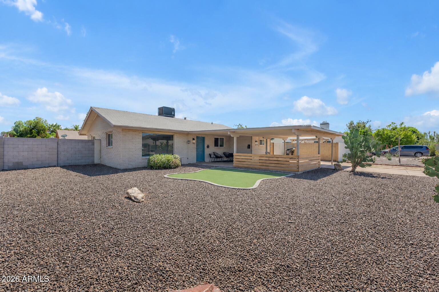 6943 East Granada Road Scottsdale, AZ 85257 - Photo 1 of 19 a front view of a house with a yard and a garage