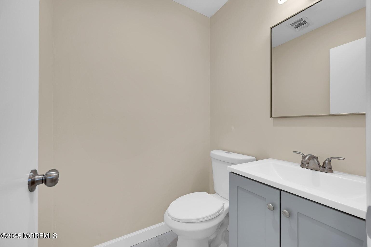 4 Cooper Court Freehold, NJ 07728 - Photo 13 of 23 a bathroom with a sink toilet and vanity