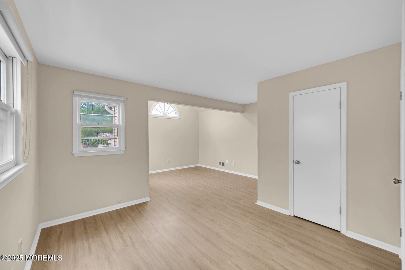 4 Cooper Court Freehold, NJ 07728 - Photo 14 of 23 an empty room with wooden floor and windows