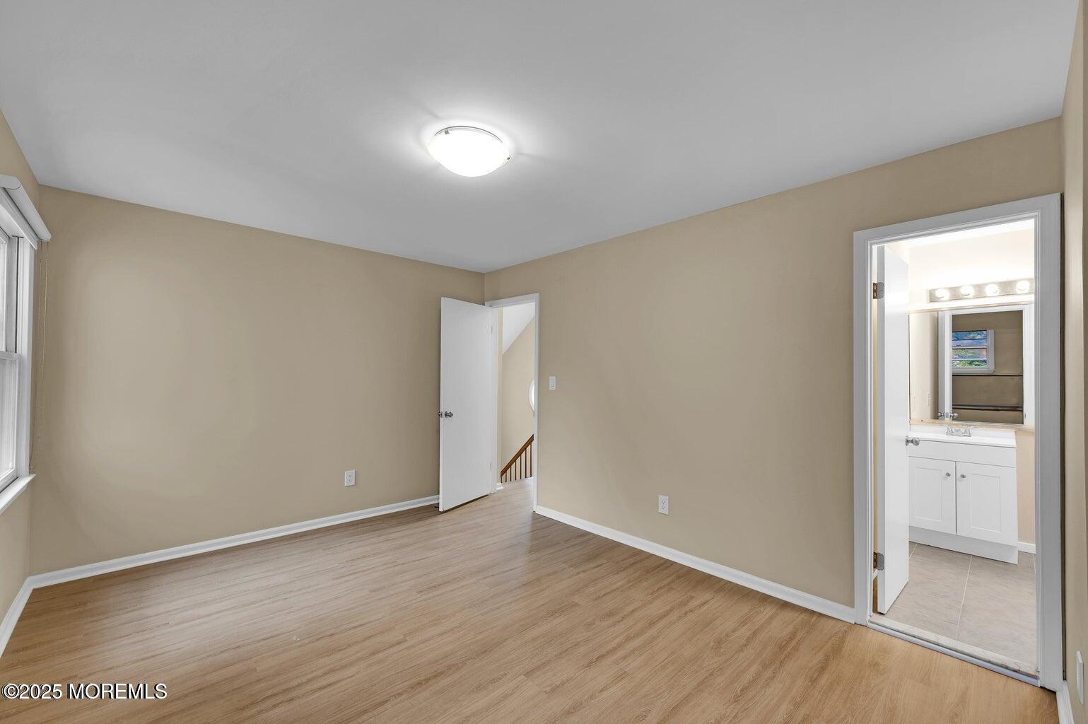 4 Cooper Court Freehold, NJ 07728 - Photo 18 of 23 an empty room with wooden floor and windows