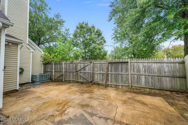 a view of backyard with wooden fence