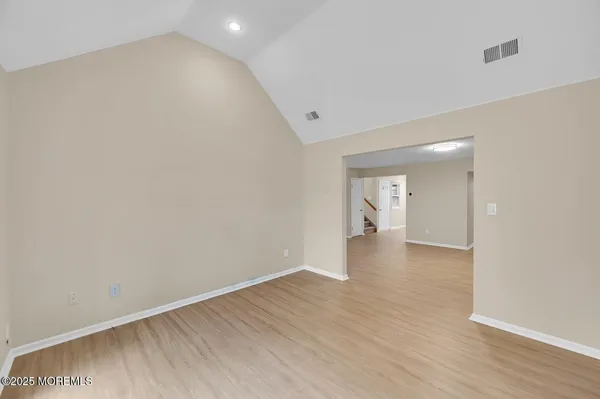 a view of an empty room and wooden floor