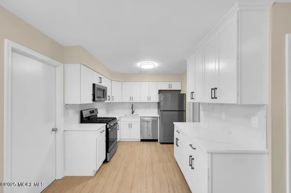 a open kitchen with cabinets microwave and refrigerator