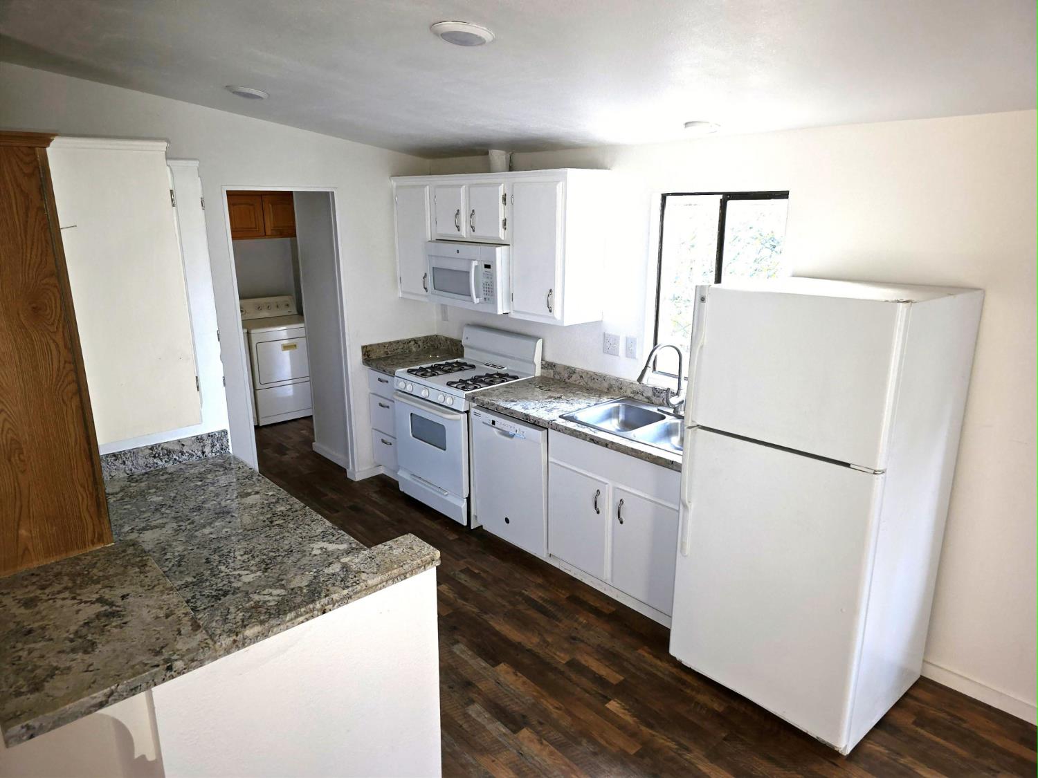 18330 Wards Ferry Road, Unit 59 Sonora, CA 95370 - Photo 5 of 10 a kitchen with a stove a refrigerator and a sink