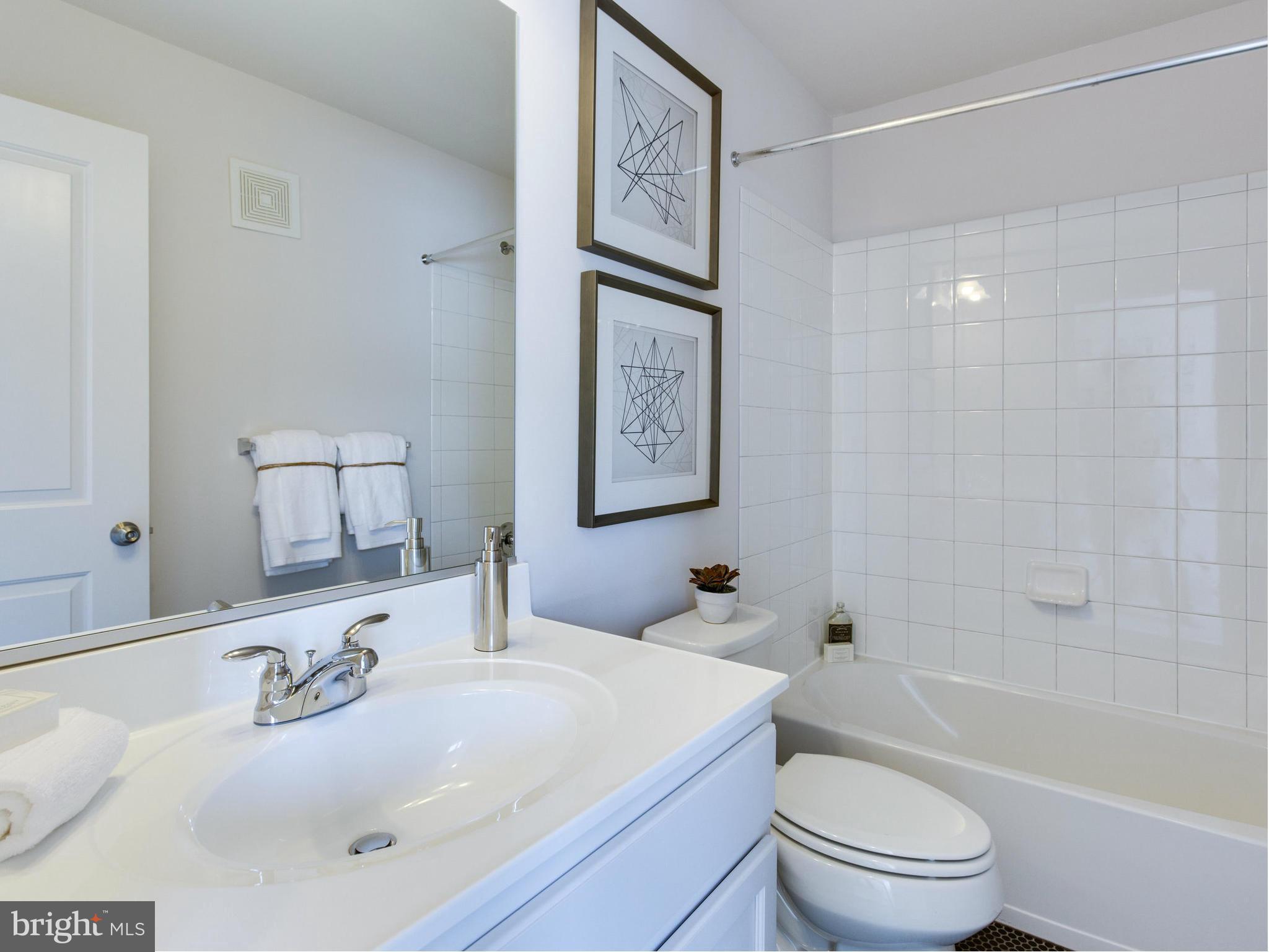 1709 Fieldstone Court Hanover, MD 21076 - Photo 11 of 19 a bathroom with a sink a toilet and shower