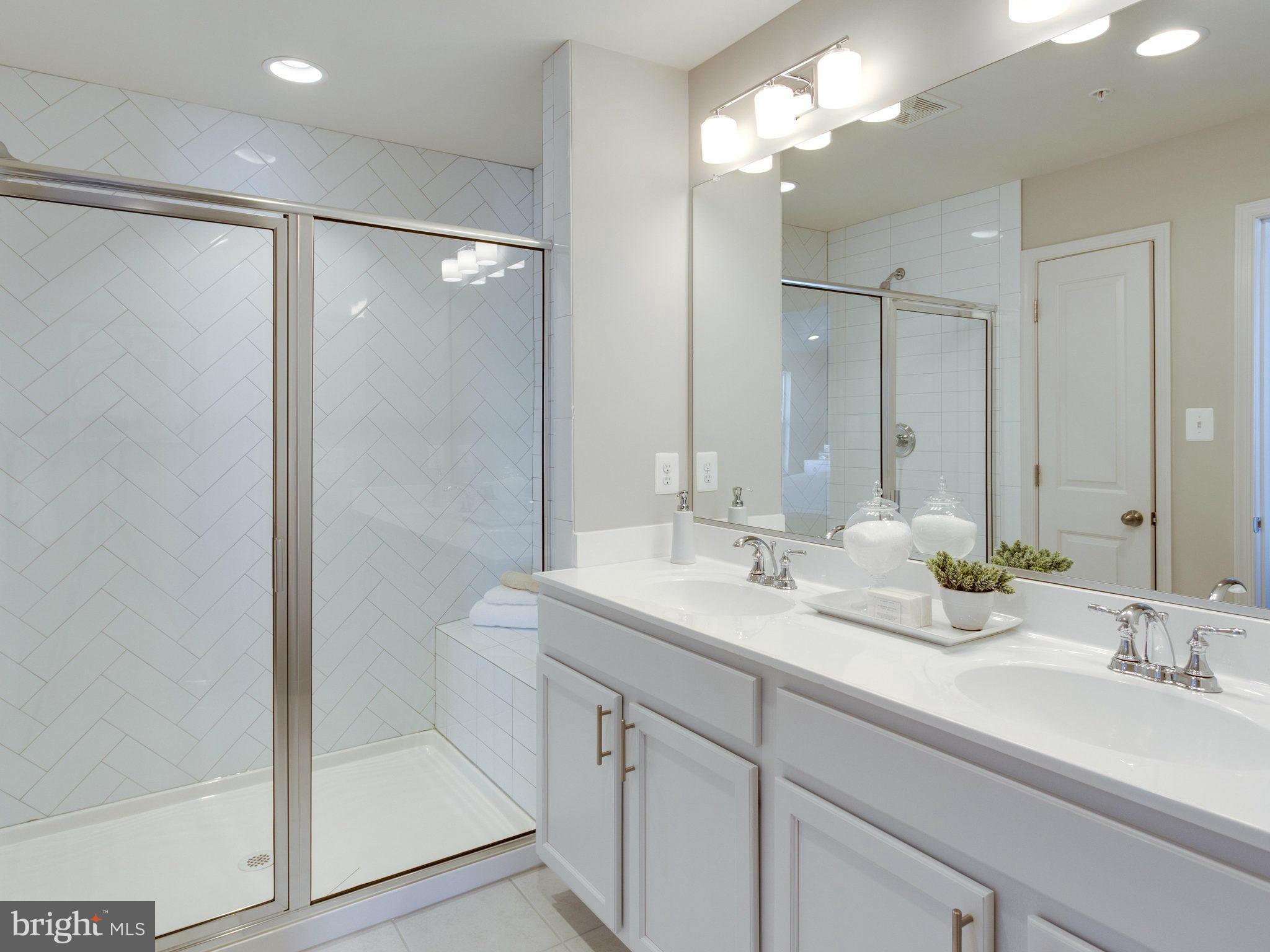 1709 Fieldstone Court Hanover, MD 21076 - Photo 17 of 19 a bathroom with a double vanity sink mirror and shower