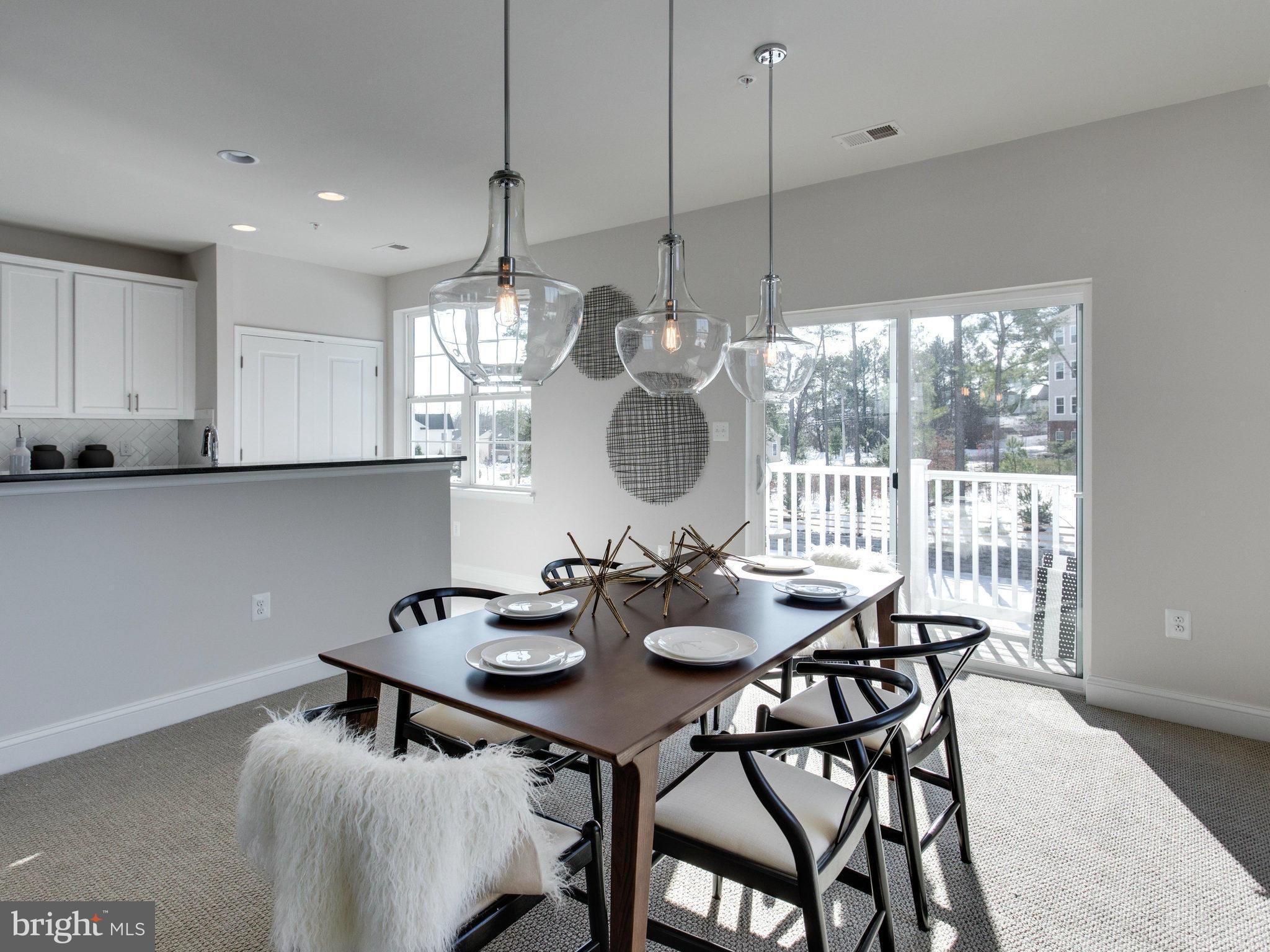 1709 Fieldstone Court Hanover, MD 21076 - Photo 7 of 19 a view of a dining room and livingroom with furniture wooden floor a chandelier