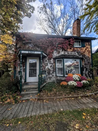 a front view of a house with garden