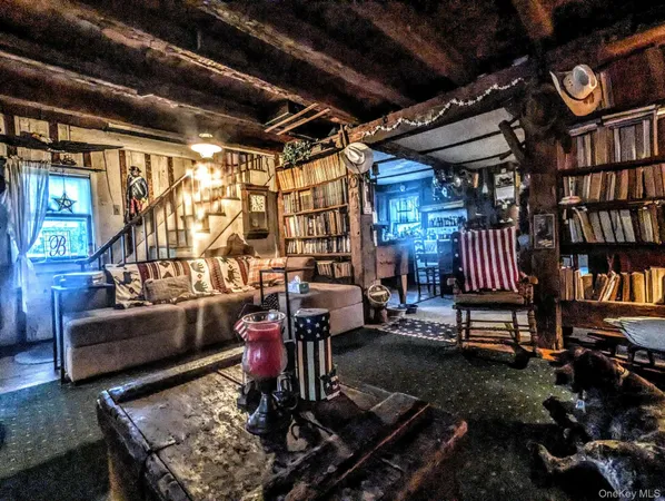 a living room with patio furniture and a chandelier
