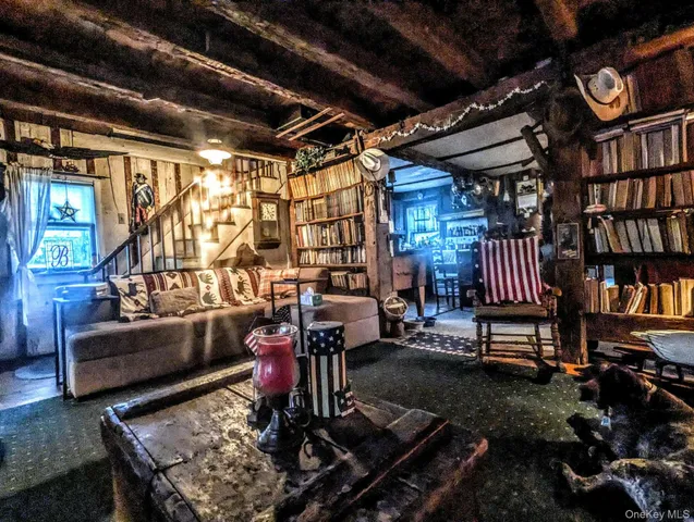 a living room with patio furniture and a chandelier