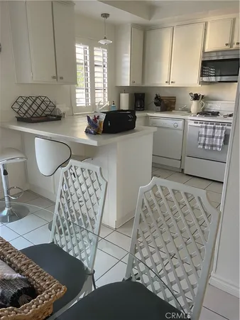 a kitchen with stainless steel appliances kitchen island granite countertop a sink and a stove