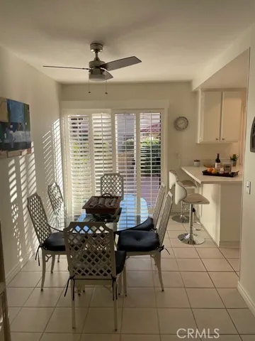 a view of a dining room with furniture and windows