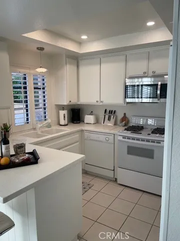 a kitchen with a stove cabinets and counter space