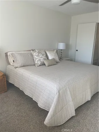 a bedroom with a white bed and white couch
