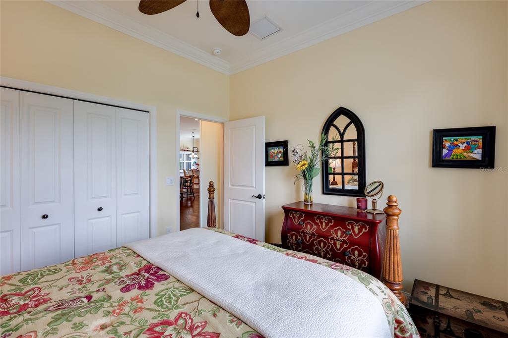 5011 Tobermory Way Bradenton, FL 34211 - Photo 22 of 77 a bedroom with a bed and a chandelier