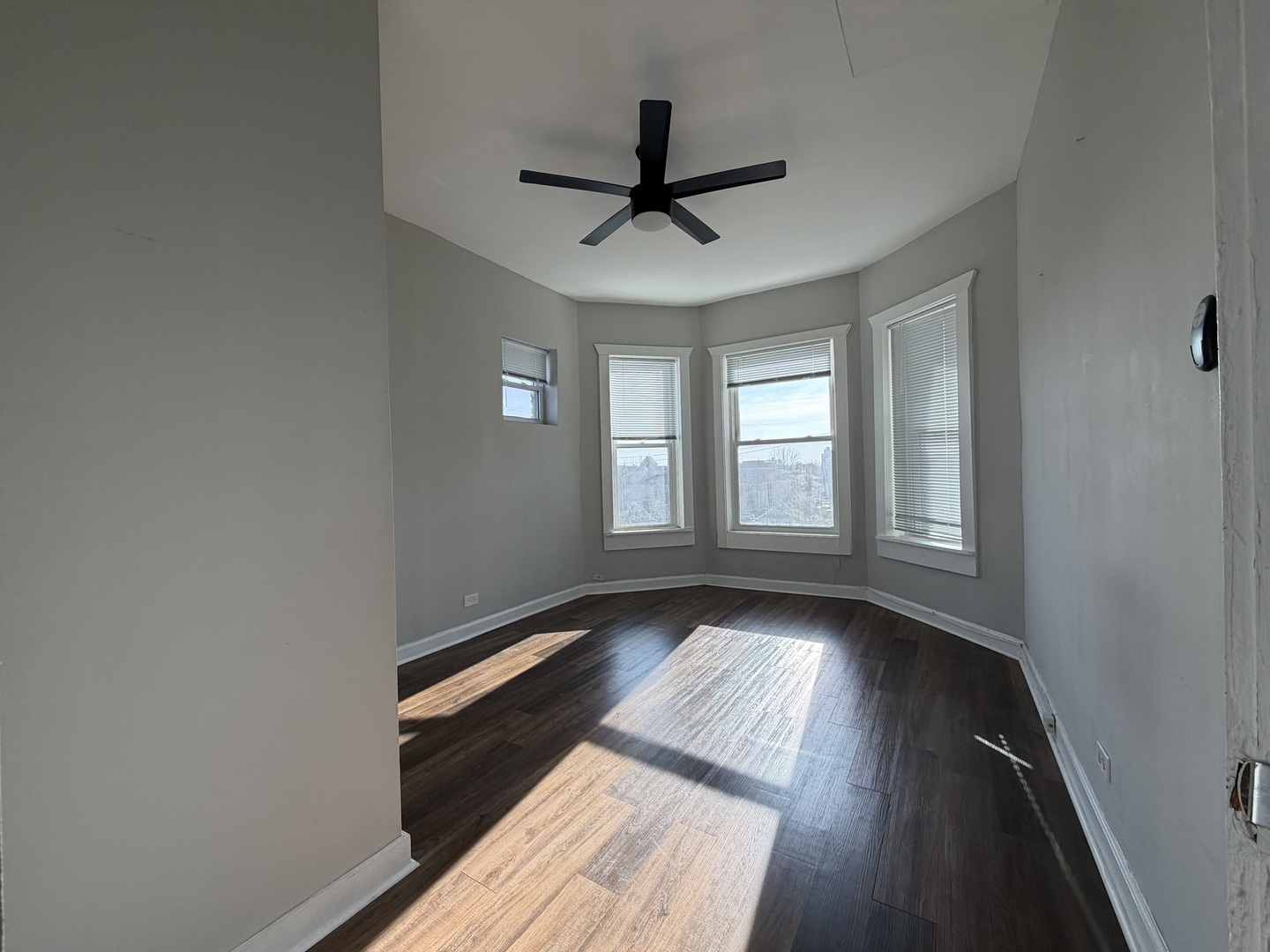 3339 West Adams Street, Unit 3E Chicago, IL 60624 - Photo 5 of 9 a view of wooden floor and a chandelier fan in a room