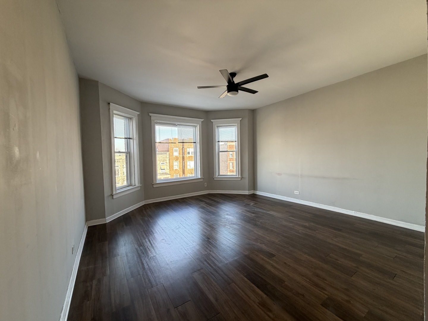 3339 West Adams Street, Unit 3E Chicago, IL 60624 - Photo 8 of 9 a view of an empty room with wooden floor and a window