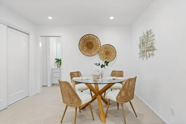 a dining room with furniture and wooden floor