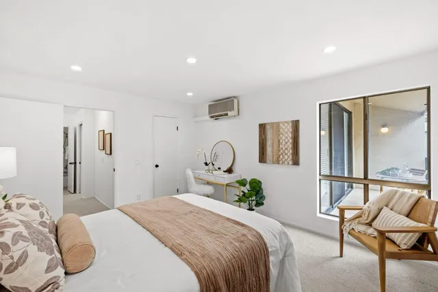 a bedroom with a bed and a chair