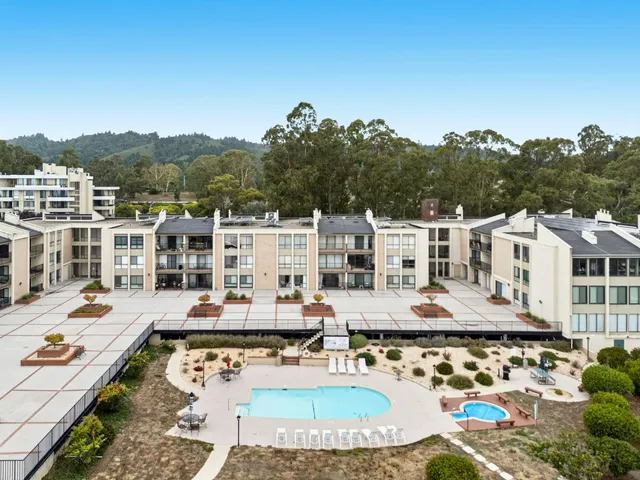a view of a swimming pool with an outdoor seating