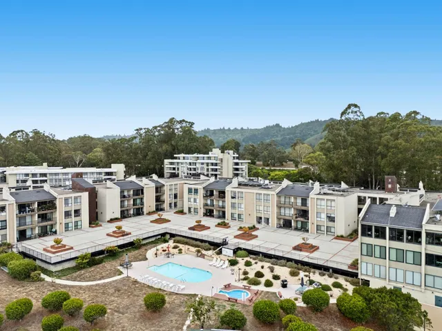 an aerial view of residential houses with outdoor space