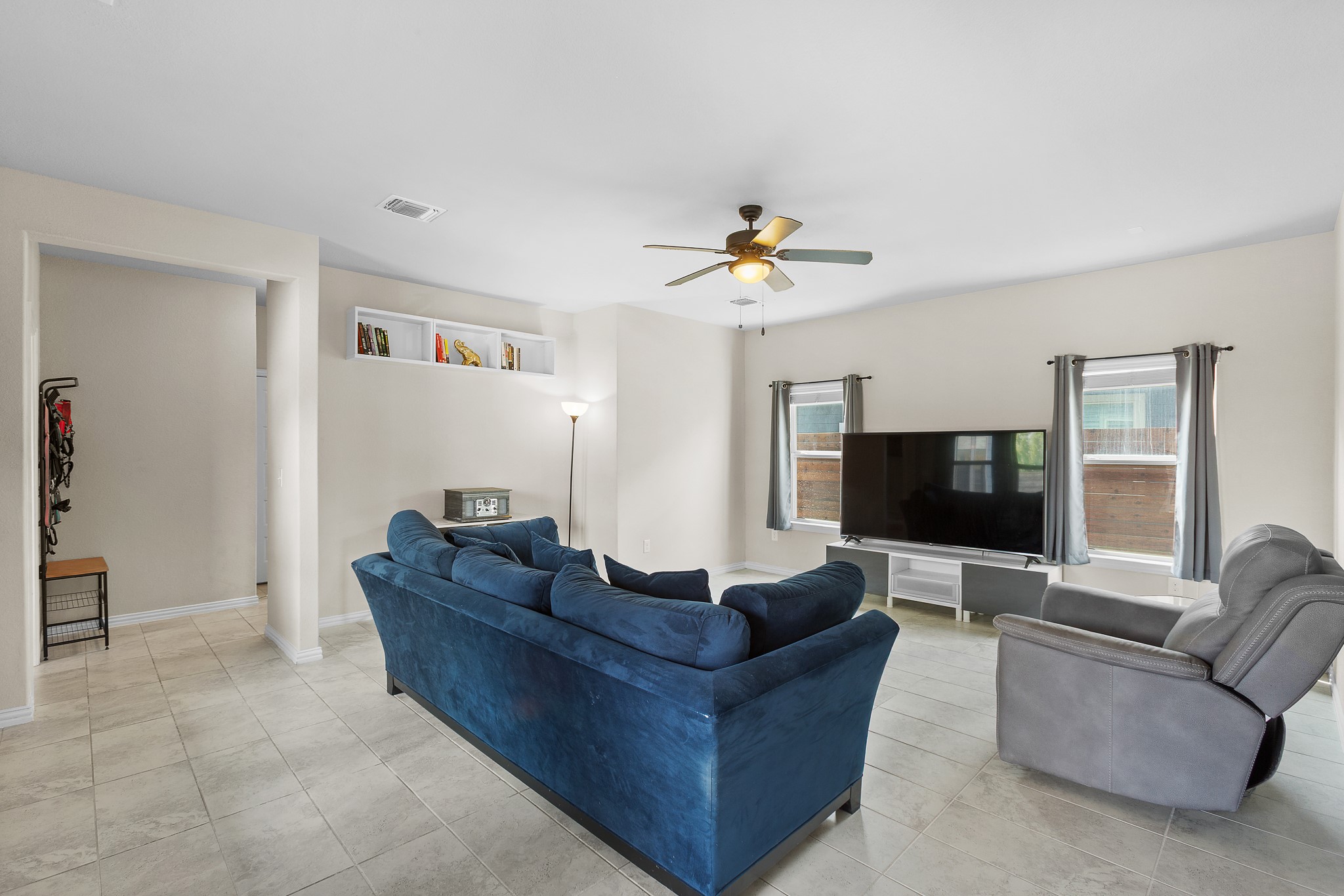 8709 Slater Drive Austin, TX 78747 - Photo 11 of 36 a living room with furniture and a flat screen tv