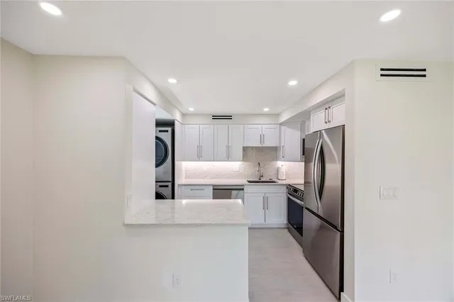 a bathroom with a granite countertop sink and a bathtub
