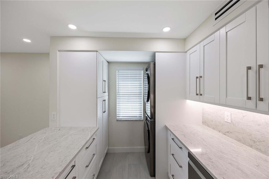 1155 Sandpiper Street, Unit F7 Naples, FL 34102 - Photo 12 of 29 a bathroom with a granite countertop sink and a bathtub