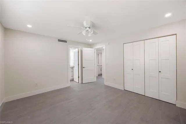 a bathroom with a granite countertop sink a toilet and shower