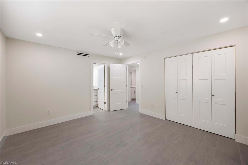 1155 Sandpiper Street, Unit F7 Naples, FL 34102 - Photo 14 of 29 an empty room with a ceiling fan & entryway