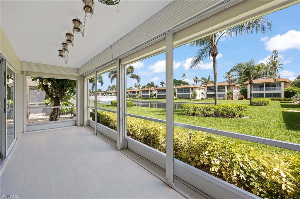 1155 Sandpiper Street, Unit F7 Naples, FL 34102 - Photo 20 of 29 a view of a porch and garden