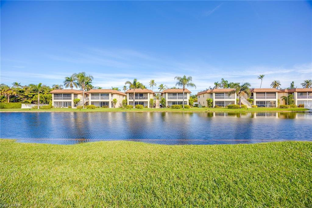 1155 Sandpiper Street, Unit F7 Naples, FL 34102 - Photo 25 of 29 a view of a swimming pool with an ocean view