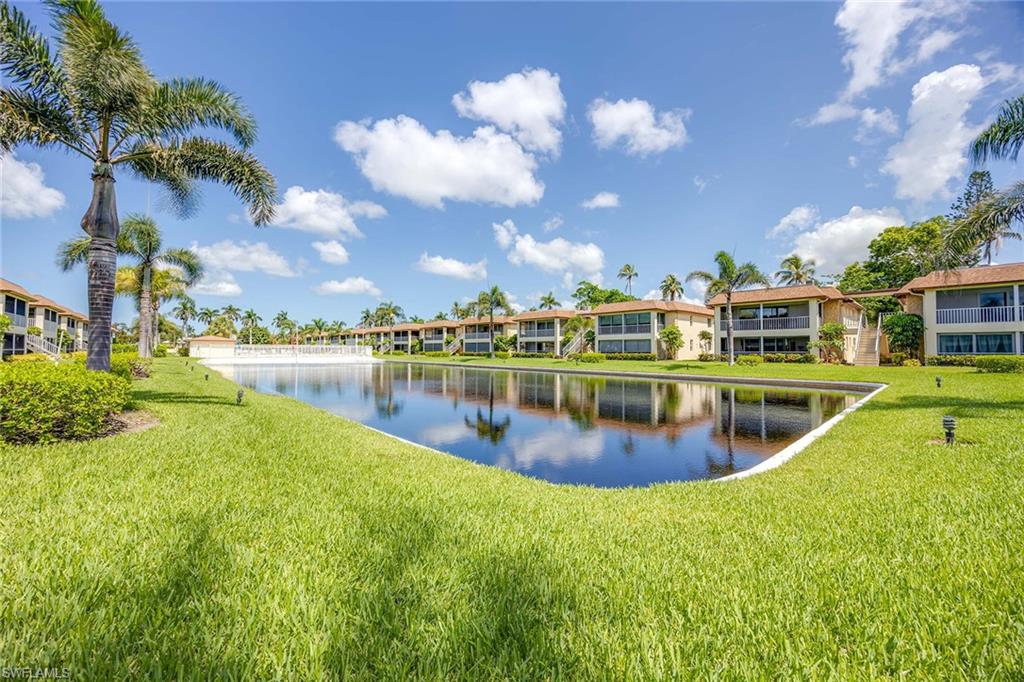 1155 Sandpiper Street, Unit F7 Naples, FL 34102 - Photo 26 of 29 a view of a lake with houses