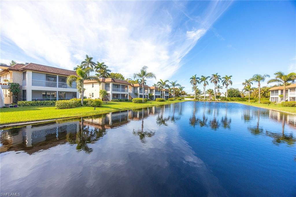 1155 Sandpiper Street, Unit F7 Naples, FL 34102 - Photo 28 of 29 a view of a lake with houses in the back