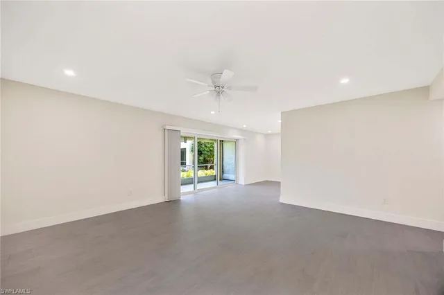 a view of a big room with kitchen and windows