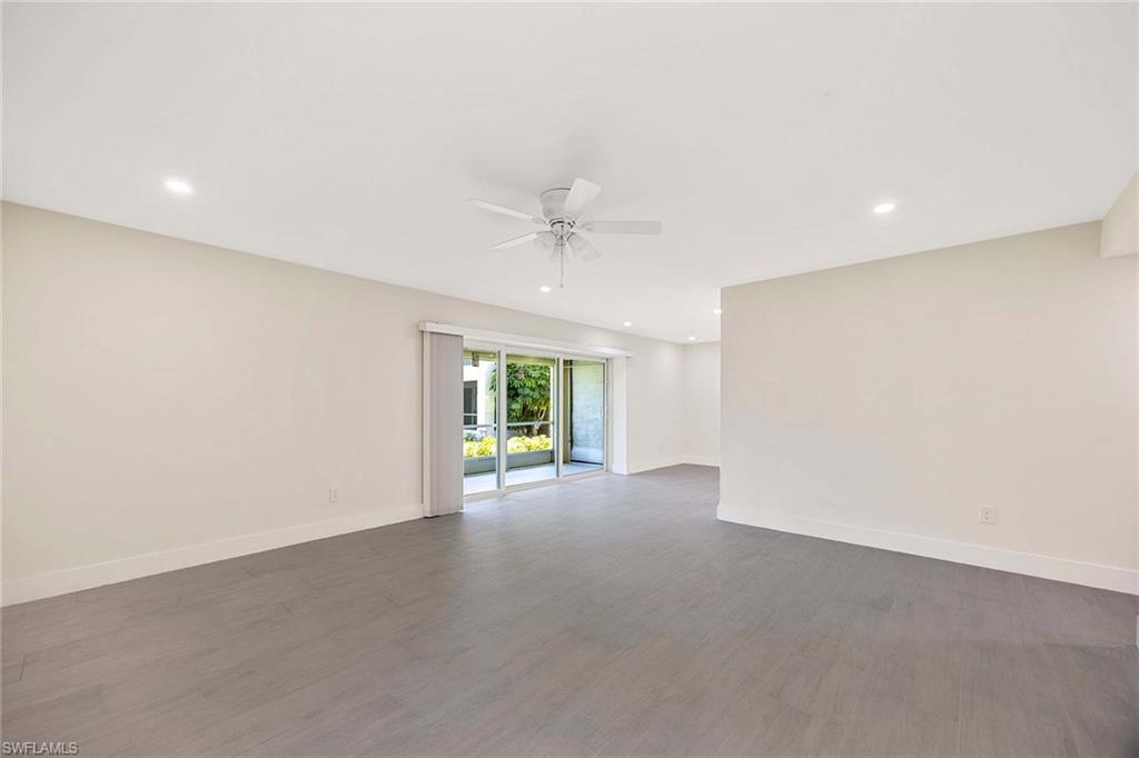 1155 Sandpiper Street, Unit F7 Naples, FL 34102 - Photo 8 of 29 an empty room with windows and ceiling fan